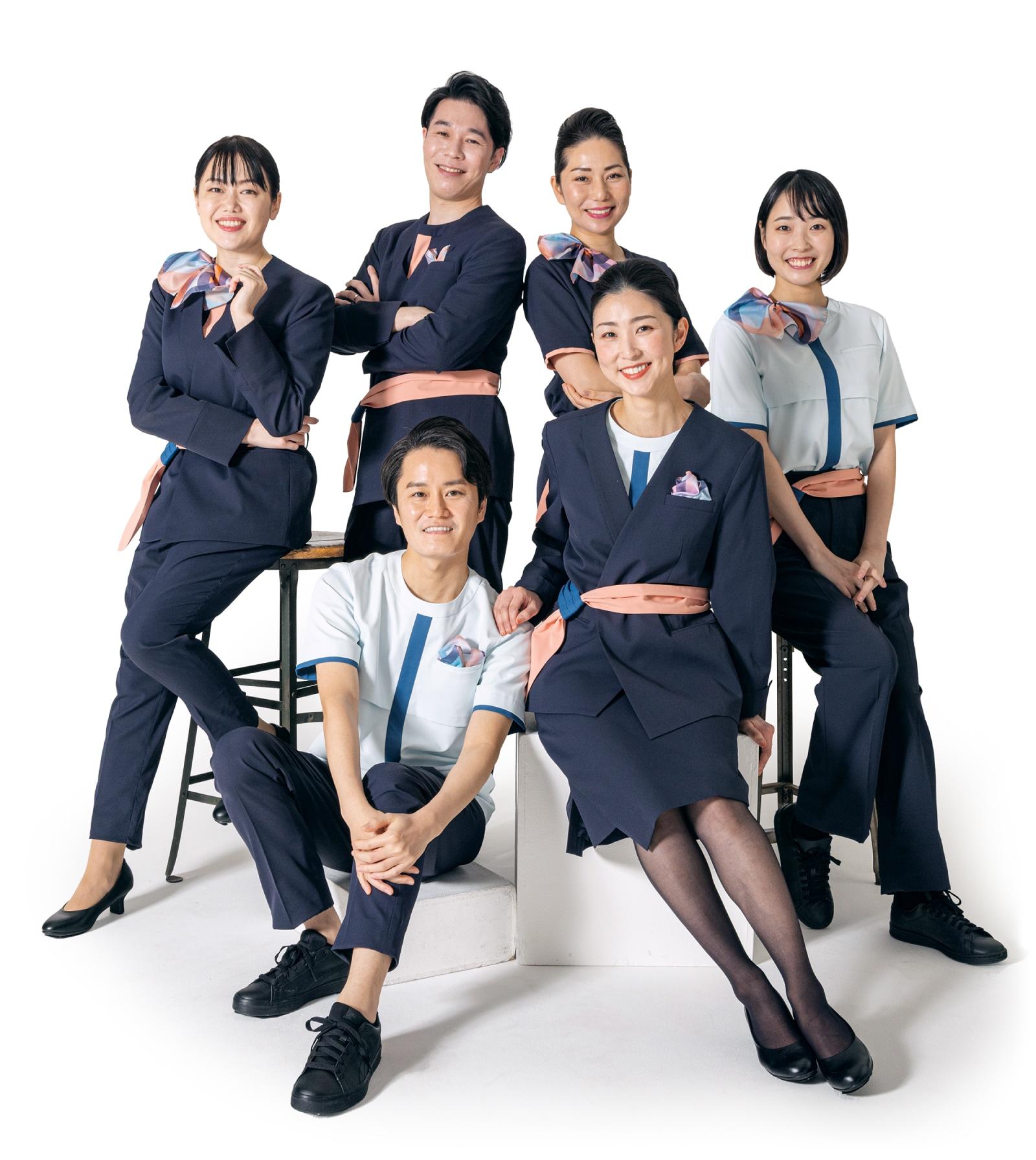 Photograph of six cabin attendants wearing Air Japan uniforms.