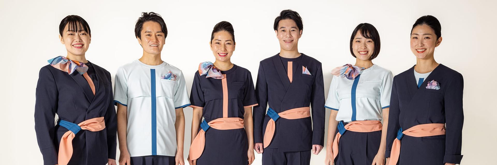 Group photograph of six cabin attendants wearing the new AirJapan uniform