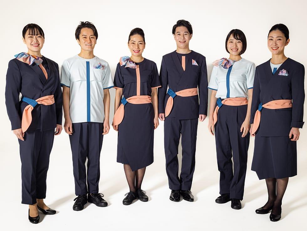 Photograph of six cabin attendants wearing the AirJapan uniform standing in a row