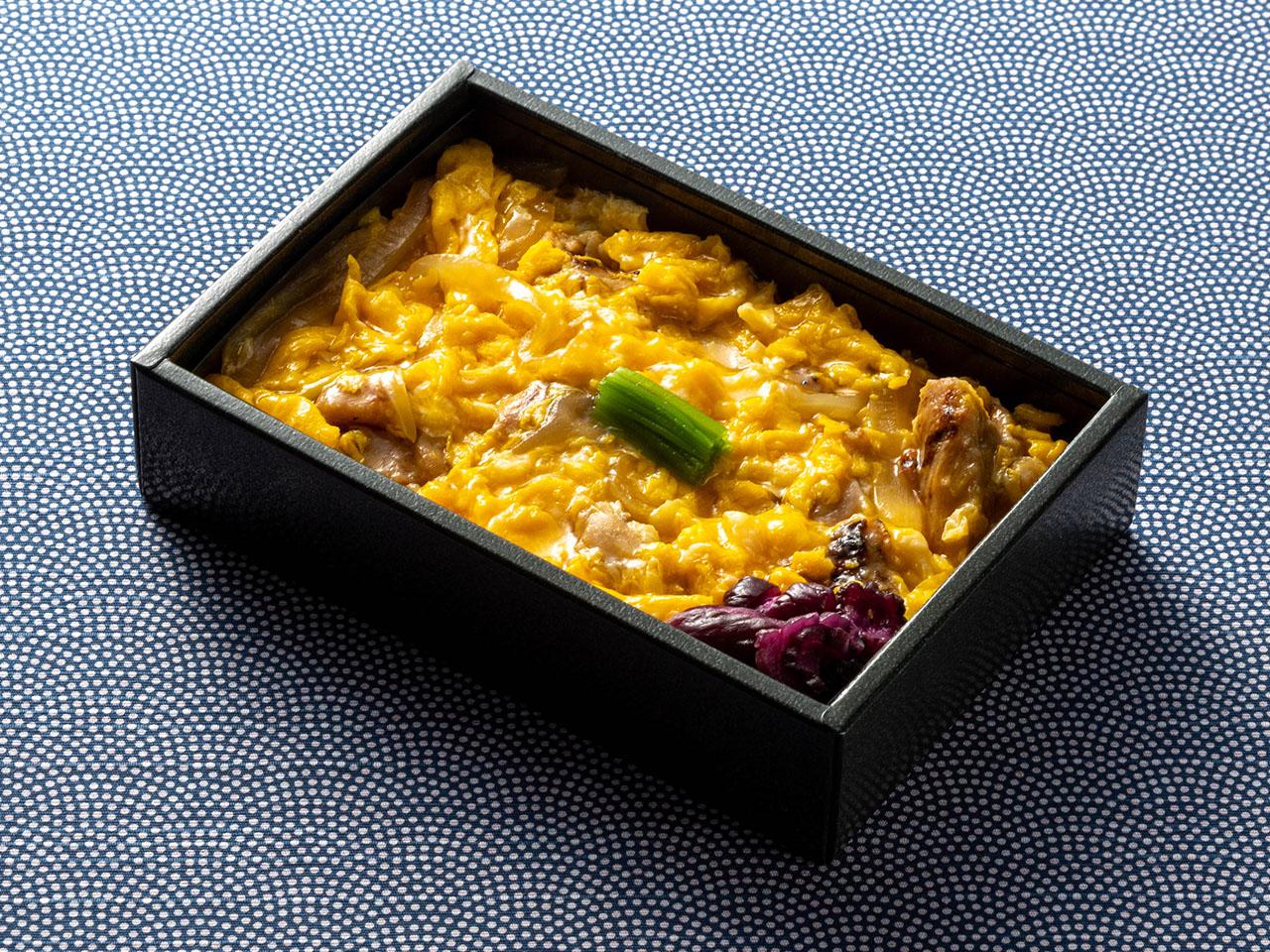 Photograph of in-flight meal: Charcoal-grilled-style Fluffy and Creamy Egg and Chicken Rice Bowl"