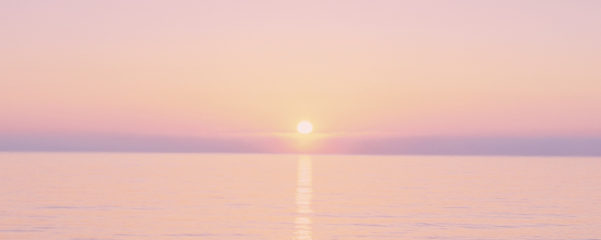 Photograph of sunrise with a dawn-colored image.